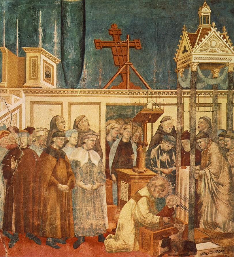 Fresk: św. Franciszek w kościele klęczy przy żłóbku i bierze na ręce Dzieciątko; wokół bracia i mieszkańcy Greccio, obok wół i osioł.